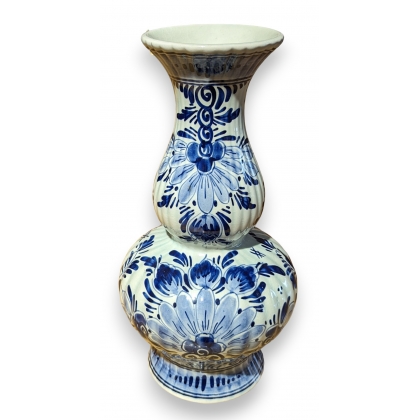 Delft-style earthenware vase with flowers