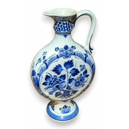 Delft-style earthenware carafe with flowers
