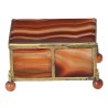 A box shaped like a casket, made of gold and orange metal