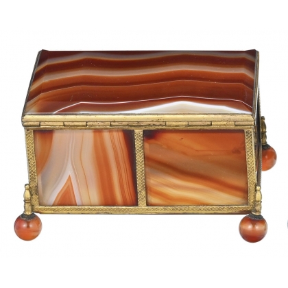 A box shaped like a casket, made of gold and orange metal
