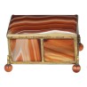 A box shaped like a casket, made of gold and orange metal