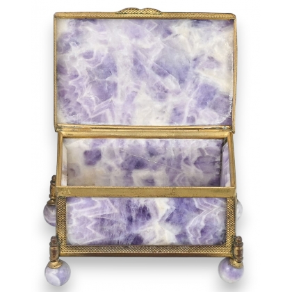 A box shaped like a casket, made of gold and purple metal