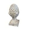 Carved stone pine cone