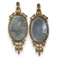 Paire de miroirs ovales en laiton ajouré