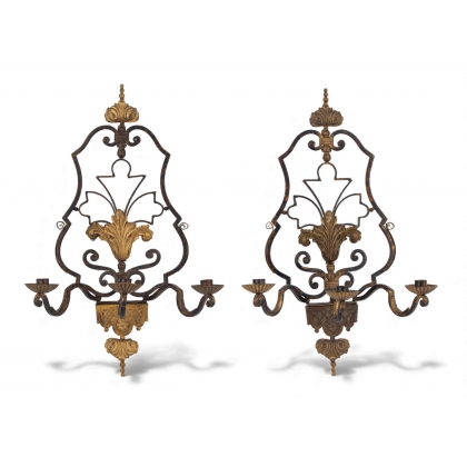 A pair of three-light wall lights in the Regency style