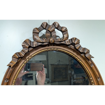 Miroir ovale style Louis XVI fronton noeud