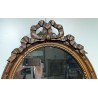 Miroir ovale style Louis XVI fronton noeud
