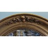 Miroir ovale Louis XVI en bois doré décor de fleur