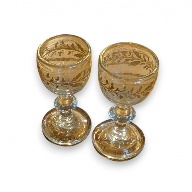 A pair of miniature glasses with gold rims