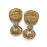 A pair of miniature glasses with gold rims