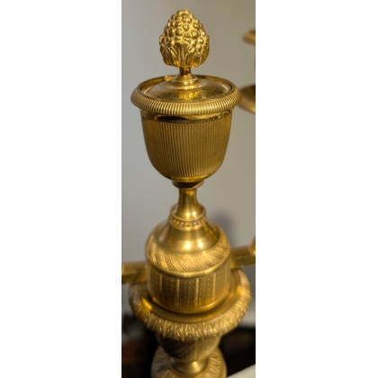 A pair of Empire-style candlesticks in gilded bronze
