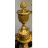A pair of Empire-style candlesticks in gilded bronze
