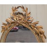 Grand miroir ovale Louis XVI doré