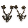 A pair of Renaissance-style bronze wall lights