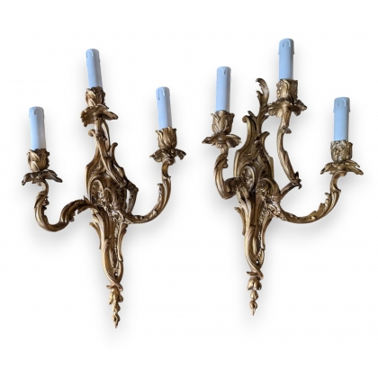 A pair of Louis XV-style wall lights with three arms