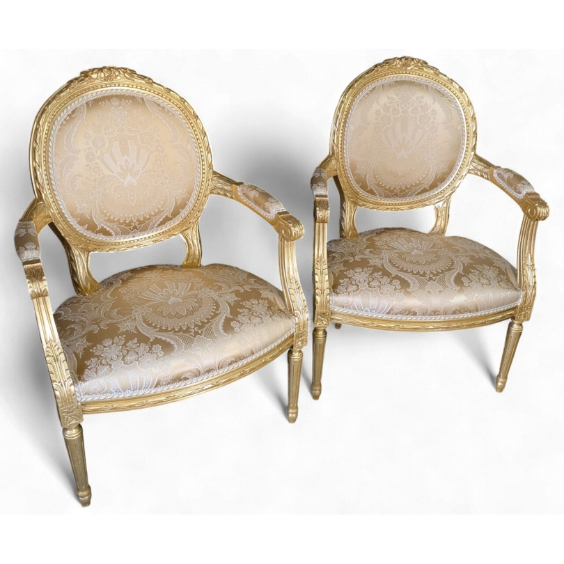 Paire de fauteuils style Louis XVI dorés