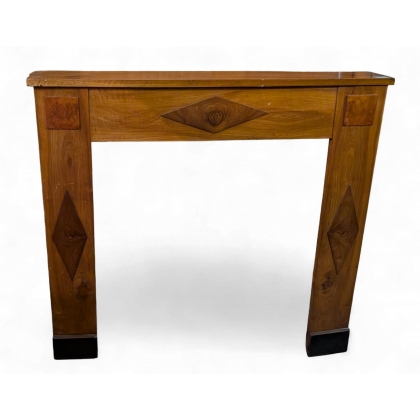 Directoire-style wooden fireplace with diamond-shaped inlays, on display at Moinat SA – Antiques and home décor