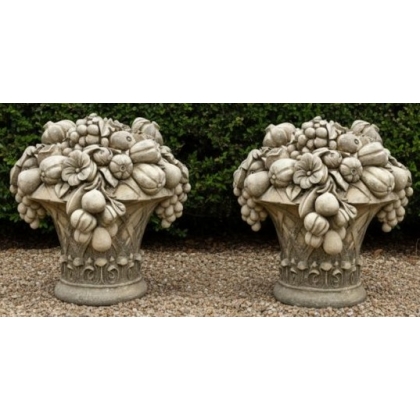 A pair of carved stone fruit bowls
