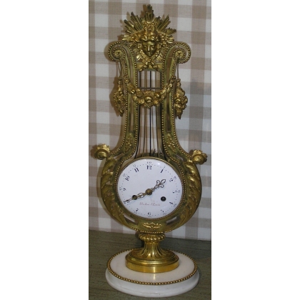 Louis XVI ‘Lyre’ clock in gilded bronze at Moinat SA – Antiques and home décor