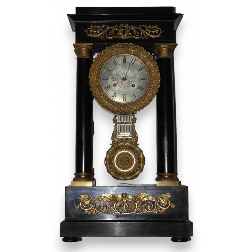 Empire-style clock with wooden columns at  Moinat SA  - Antiques and home décor