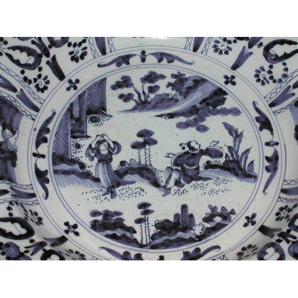 Round plate from DELFT. Decorated with figures. Available from  Moinat SA  - Antiques and home décor