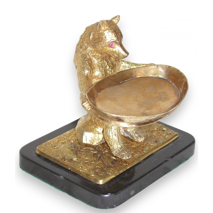 Gilt bronze bear holding a tray on black base.
