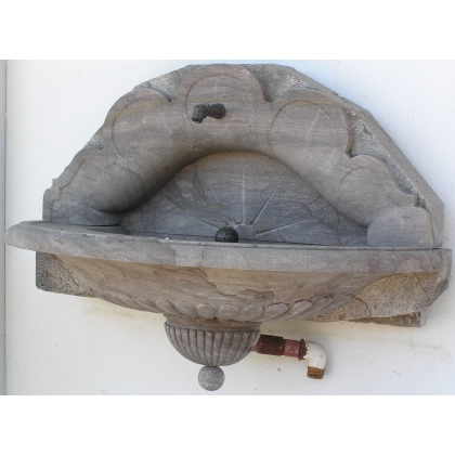 Half-moon wall fountain, made of Sous-Vent stone. Available from Moinat SA – Antiques and Decor