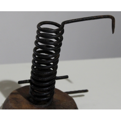 Coiled iron candle holder with a wooden base