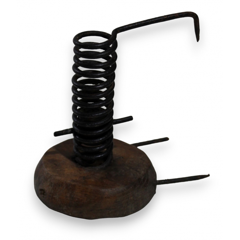 Coiled iron candle holder with a wooden base