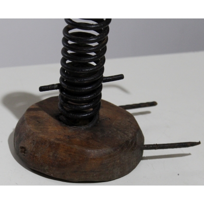 Coiled iron candle holder with a wooden base