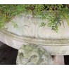 A half-moon-shaped basin resting on three lions