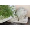 A half-moon-shaped basin resting on three lions