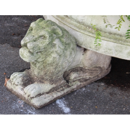 A half-moon-shaped basin resting on three lions