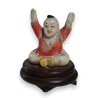 Netsuke Enfant assis les bras en l\'air
