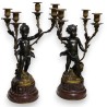 A pair of candlesticks depicting Cupids, signed L. GRÉGOIRE