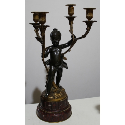 A pair of candlesticks depicting Cupids, signed L. GRÉGOIRE