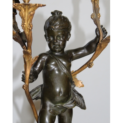 A pair of candlesticks depicting Cupids, signed L. GRÉGOIRE
