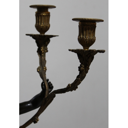 A pair of candlesticks depicting Cupids, signed L. GRÉGOIRE