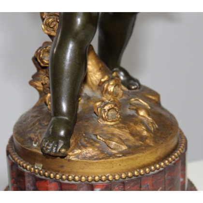 A pair of candlesticks depicting Cupids, signed L. GRÉGOIRE