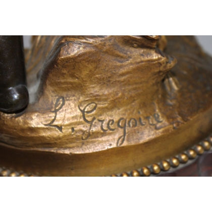 A pair of candlesticks depicting Cupids, signed L. GRÉGOIRE
