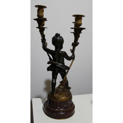 A pair of candlesticks depicting Cupids, signed L. GRÉGOIRE