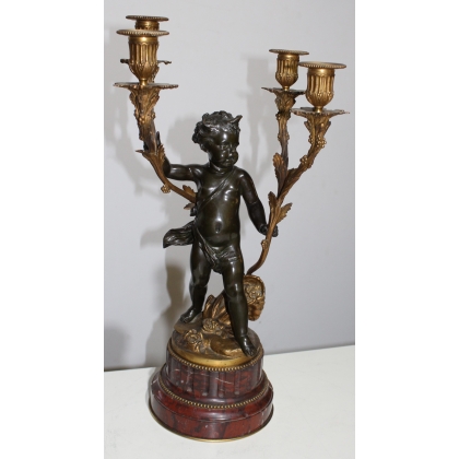 A pair of candlesticks depicting Cupids, signed L. GRÉGOIRE