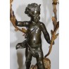 A pair of candlesticks depicting Cupids, signed L. GRÉGOIRE