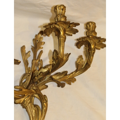 A pair of Louis XV-style bronze wall sconces
