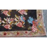 Kilim rug with a rose pattern on a black background