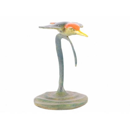 A kingfisher in flight, in polychrome bronze