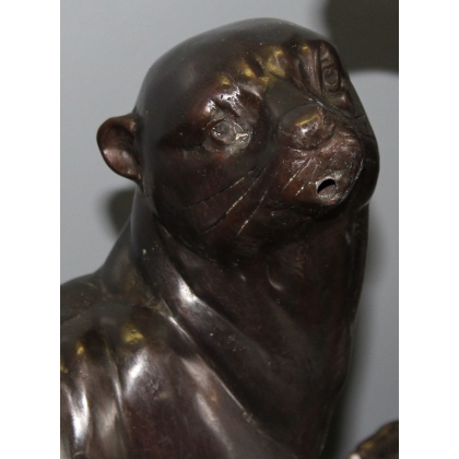 A pair of otters on a branch, cast in bronze