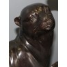 A pair of otters on a branch, cast in bronze