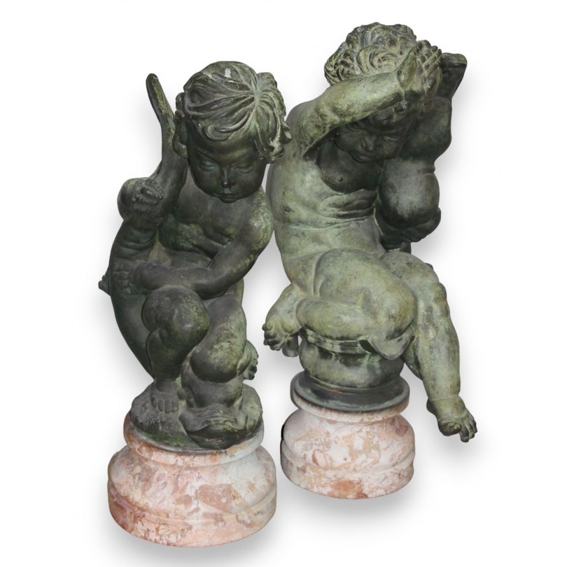 Pair of bronze putti on marble plinths
