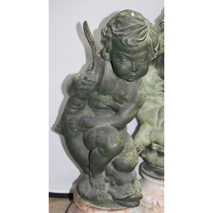 Pair of bronze putti on marble plinths
